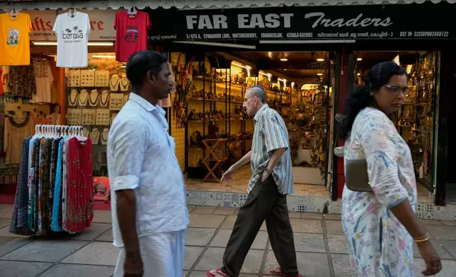 Keith Hallegua, center, walks past a handicrafts store toward the 458-year-old Paradesi Synagogue in the historic Jew Town neighborhood of Kochi, India, Thursday, May 21, 2026. (AP Photo/Aijaz Rahi)