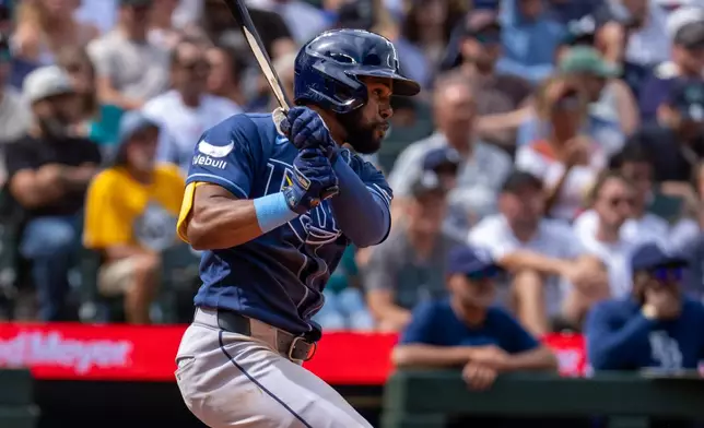 Tampa Bay Rays' Cedric Mullins hits an RBI single during the fifth inning of a baseball game against the Seattle Mariners, Sunday, Aug. 9, 2026, in Seattle. (AP Photo/Stephen Brashear)