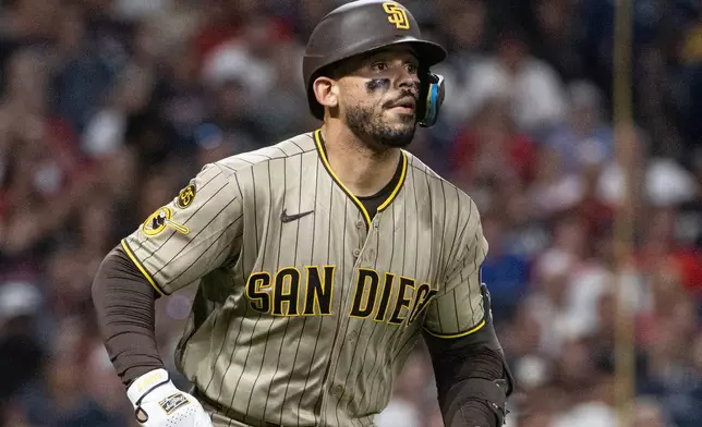 San Diego Padres' Luis Campusano watches his RBI double of Cleveland Guardians relief pitcher Colin Holderman during the seventh inning of a baseball game, Friday, Aug. 14, 2026, in Cleveland. (AP Photo/Phil Long)