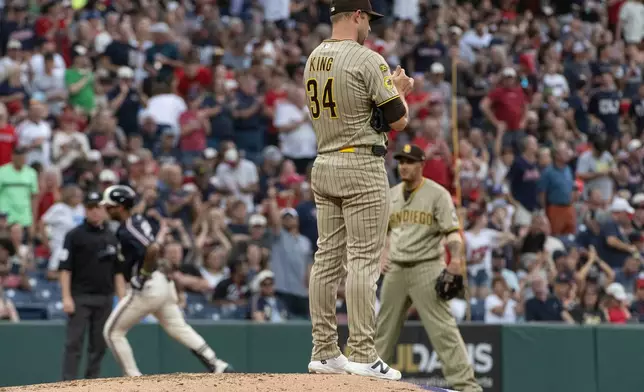 San Diego Padres starting pitcher Michael King (34) turns his back on home plate as Cleveland Guardians' Brayan Rocchio rounds the bases after hitting a solo home run during the third inning of a baseball game, Friday, Aug. 14, 2026, in Cleveland. (AP Photo/Phil Long)