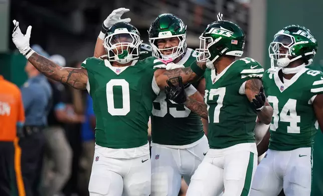 New York Jets running back Braelon Allen (0) celebrates with teammates after a touchdown run during the first half of a preseason NFL football game against the Tampa Bay Buccaneers, Friday, Aug. 14, 2026, in East Rutherford, N.J. (AP Photo/Frank Franklin II)