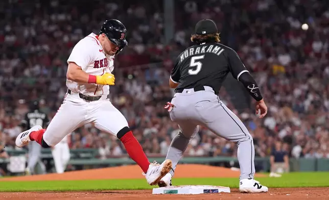 Boston Red Sox's Caleb Durbin, left, beats the throw to Chicago White Sox's Munetaka Murakami (5) on a single during the fourth inning of a baseball game, Thursday, Aug. 6, 2026, in Boston. (AP Photo/Charles Krupa)