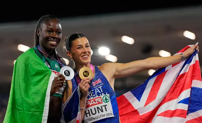 Amy Hunt of Britain celebrates winning the gold medal with Rhasidat Adeleke of Ireland, who took the silver, in the women's 200 meters final at the European Athletics Championships in Birmingham, England, Thursday, Aug. 13, 2026. (AP Photo/Petr David Josek)