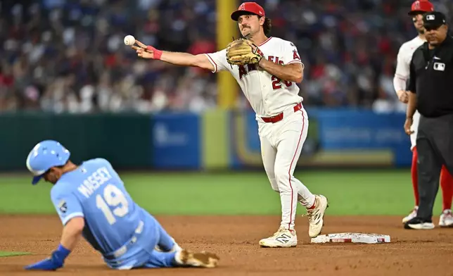 Los Angeles Angels second baseman Adam Frazier, center, throws for a double play after forcing out Kansas City Royals' Michael Massey during the fifth inning of a baseball game Saturday, Aug. 15, 2026, in Anaheim, Calif. (AP Photo/William Liang)