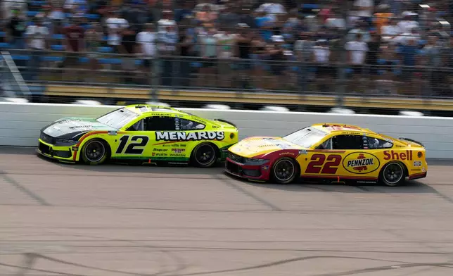 Ryan Blaney (12) battles for position with Joey Logano (22) during a NASCAR Cup Series auto race, Sunday, Aug. 9, 2026, at Iowa Speedway in Newton, Iowa. (AP Photo/Charlie Neibergall)