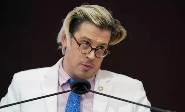 FILE - Activist Milo Yiannopoulos speaks during a rally outside of the Baltimore hotel where the United States Conference of Catholic Bishops are holding its Fall General Assembly meeting in Baltimore, Nov. 16, 2021. (AP Photo/Julio Cortez, File)