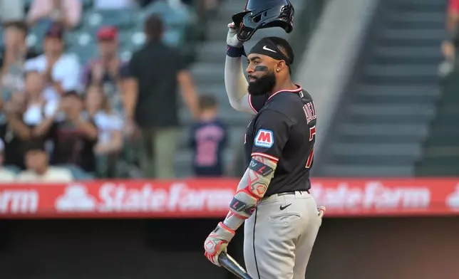 Cleveland Guardians' Jo Adell tips his batting helmet to fans during an at-bat in the first inning of a baseball game against the Los Angeles Angels, Monday, Aug. 24, 2026, in Anaheim, Calif. (AP Photo/Jayne Kamin-Oncea)