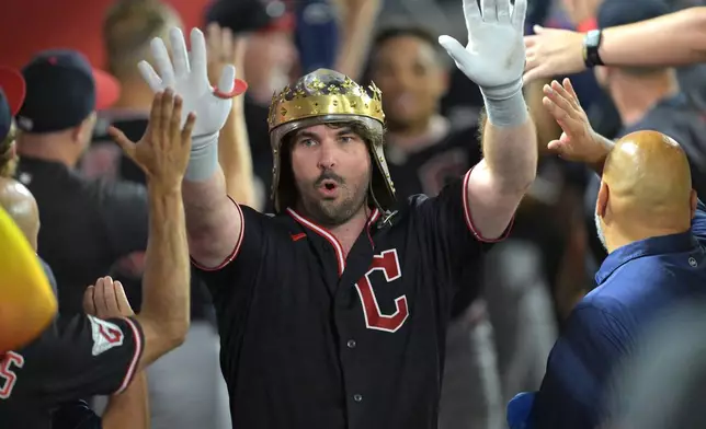 Cleveland Guardians' Austin Hedges is congratulated in the dugout after hitting a two-run home run during the sixth inning of a baseball game against the Los Angeles Angels, Monday, Aug. 24, 2026, in Anaheim, Calif. (AP Photo/Jayne Kamin-Oncea)