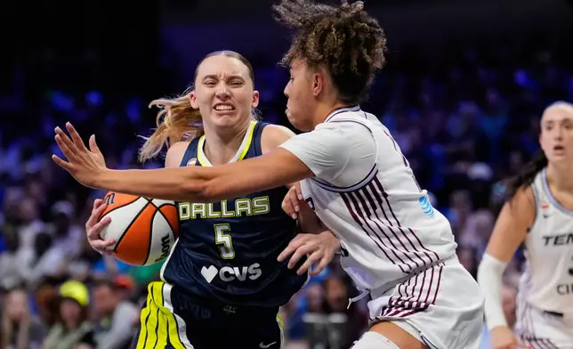 Dallas Wings guard Paige Bueckers drives to the basket as Toronto Tempo's Kiki Rice, right, defends in the first half of a WNBA basketball game in Arlington, Texas, Wednesday, Aug. 12, 2026. (AP Photo/Tony Gutierrez)