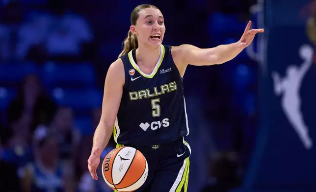 Dallas Wings guard Paige Bueckers instructs teammates in the first half of a WNBA basketball game against the Toronto Tempo in Arlington, Texas, Wednesday, Aug. 12, 2026. (AP Photo/Tony Gutierrez)