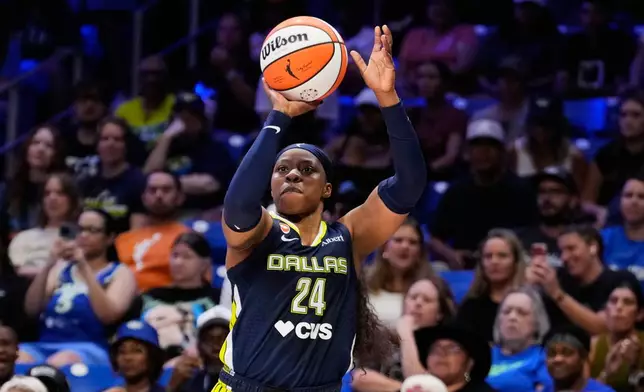 Dallas Wings guard Arike Ogunbowale (24) shoots a three-pointer in the first half of a WNBA basketball game against the Toronto Tempo in Arlington, Texas, Wednesday, Aug. 12, 2026. (AP Photo/Tony Gutierrez)