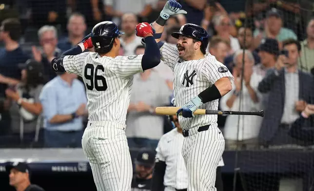 New York Yankees' Austin Wells, right, celebrates with George Lombard Jr. Lombard's home run during the fifth inning of a baseball game against the St. Louis Cardinals Tuesday, Aug. 4, 2026, in New York. (AP Photo/Frank Franklin II)