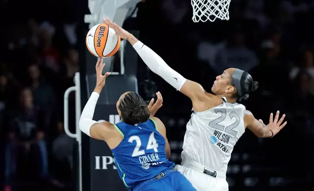 Las Vegas Aces center A'ja Wilson (22) blocks a shot by Minnesota Lynx forward Napheesa Collier (24) during the first half of a WNBA basketball game Saturday, Aug. 15, 2026, in Las Vegas. (Steve Marcus/Las Vegas Sun via AP)