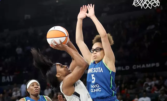 Las Vegas Aces guard Jackie Young shoots against Minnesota Lynx guard Olivia Miles (5) during the first half of a WNBA basketball game Saturday, Aug. 15, 2026, in Las Vegas. (Steve Marcus/Las Vegas Sun via AP)