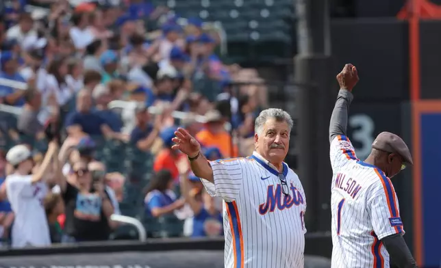 Keith Hernandez, left, acknowledges the crowd next to Mookie Wilson during a celebration for the 1986 New York Mets team that won a World Series, Saturday, Aug. 1, 2026, in New York. (AP Photo/Heather Khalifa)