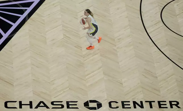 Dallas Wings guard Paige Bueckers brings the ball up the court against the Golden State Valkyries during the first half of a WNBA basketball game in San Francisco, Monday, Aug. 17, 2026. (AP Photo/Jeff Chiu)