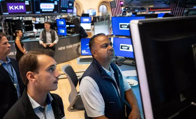 Specialists Dilip Patel, right, and Dylan Halvorsen work on the floor of the New York Stock Exchange in New York, Friday, Aug. 21, 2026. (AP Photo/Yuki Iwamura)