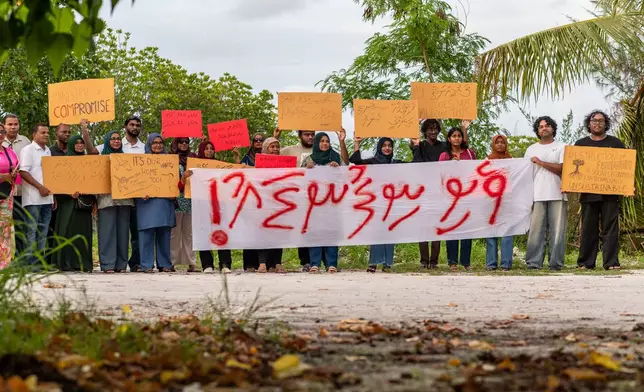 Members of Project ThimaaVeshi, team up with Veshi Saafu, a group of older women who also campaign on environmental matters, to demonstrate against ongoing reclamation projects on World Environmental Day in Addu City, Maldives, June 5, 2026. (AP Photo/Sophia Nasif)
