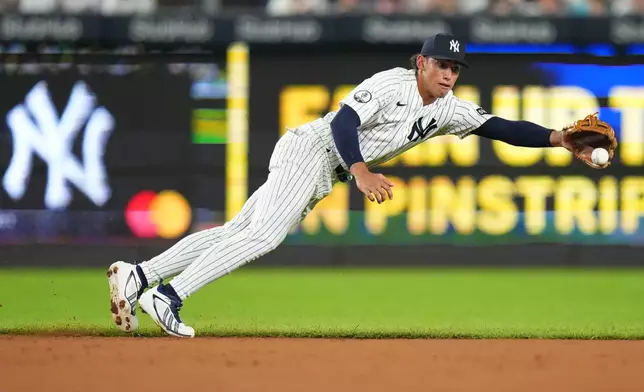 New York Yankees' George Lombard Jr. dives for a ball hit by St. Louis Cardinals' JJ Wetherholt during the third inning of a baseball game Wednesday, Aug. 5, 2026, in New York. (AP Photo/Frank Franklin II)