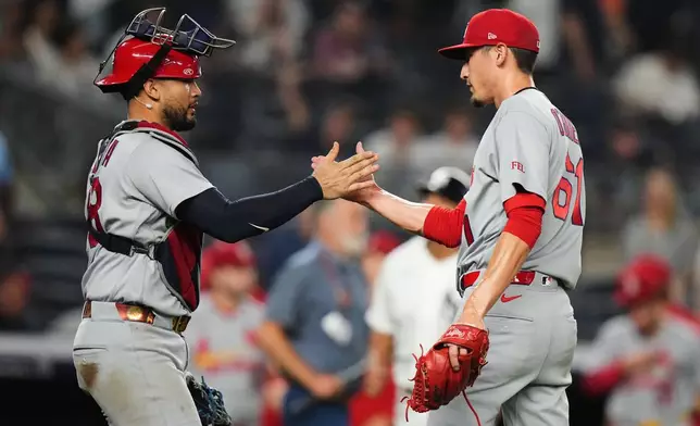 St. Louis Cardinals designated hitter Iván Herrera, left, celebrates with pitcher Riley O'Brien (61) after a baseball game against the New York Yankees Wednesday, Aug. 5, 2026, in New York. (AP Photo/Frank Franklin II)