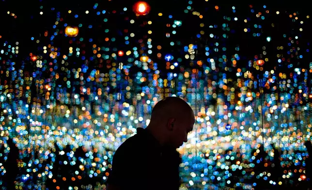 FILE - Redan Magbanua views Yayoi Kusama's Infinity Mirrored Room at the Broad museum, Tuesday, Nov. 10, 2015, in downtown Los Angeles. The contemporary art museum founded by philanthropist Eli Broad opened in September. (AP Photo/Jae C. Hong, File)