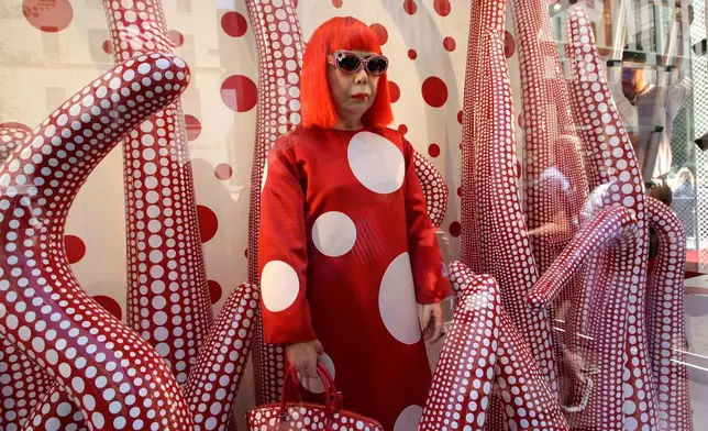 FILE - A wax model of Japanese artist Yayoi Kusama is displayed in the windows of Louis Vuitton's flagship Fifth Avenue store in New York, Tuesday, July 10, 2012. (AP Photo/Kathy Willens, File)