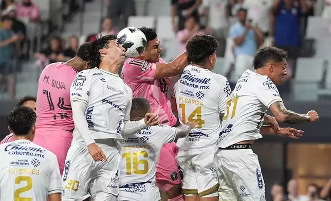 Inter Miami defender Micael (14) heads the ball past Atletico de San Luis defender Benjamin Galindo (30) and Inter Miami midfielder Casemiro (5) to score the team's fourth goal during the first half of a Leagues Cup soccer match, Wednesday, Aug. 5, 2026, in Miami. (AP Photo/Rebecca Blackwell)