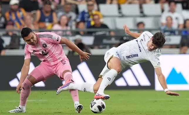 Inter Miami midfielder Casemiro (5) battles with Atletico de San Luis forward Rafa Llorente, right, during the first half of a Leagues Cup soccer match, Wednesday, Aug. 5, 2026, in Miami. (AP Photo/Rebecca Blackwell)