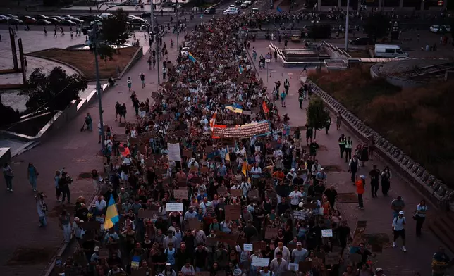 People march during a rally to protest the dismissal of Mykhailo Fedorov as Ukraine's Defense Minister in Kyiv, late Sunday, Aug. 16, 2026. (AP Photo/Francisco Seco)