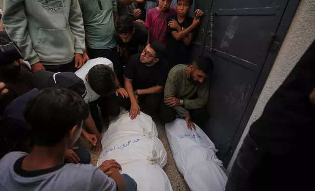 Mourners attend the funeral of Palestinians who were killed in an Israeli army strike on a cafe at the Gaza port the previous day, at Shifa Hospital in Gaza City, Wednesday, Aug. 19, 2026. (AP Photo/Jehad Alshrafi)