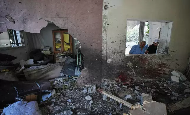 Palestinians inspect the damage at a police station that was hit by an Israeli airstrike in Gaza City, Wednesday, Aug. 19, 2026. (AP Photo/Jehad Alshrafi)
