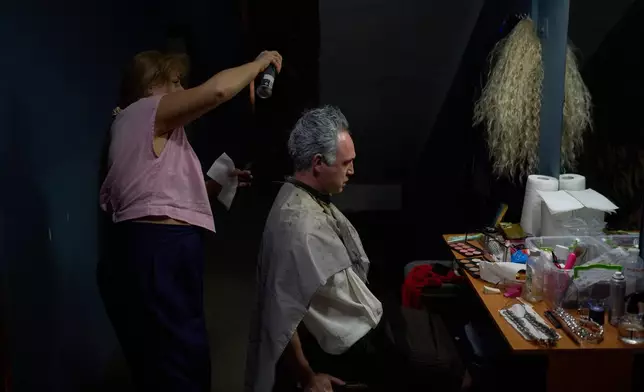 An actor gets his hair styled backstage before the final rehearsal of "Odyssey. Maeotis," which reimagines Homer’s epic, at Ivan Franko theater in Kyiv, Tuesday, Aug. 25, 2026. (AP Photo/Francisco Seco)