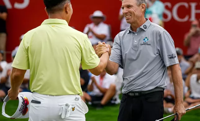 New Zealand's Stephen Alker, right, is congratulated by Korea's Y. E. Yang after winning the PGA Tour Champions golf event in Calgary, Alberta, Sunday, Aug. 23, 2026. (Jeff McIntosh/The Canadian Press via AP)