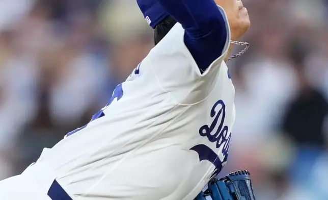 Los Angeles Dodgers starting pitcher Yoshinobu Yamamoto throws to the plate during the first inning of a baseball game against the Milwaukee Brewers, Friday, Aug. 14, 2026, in Los Angeles. (AP Photo/Mark J. Terrill)