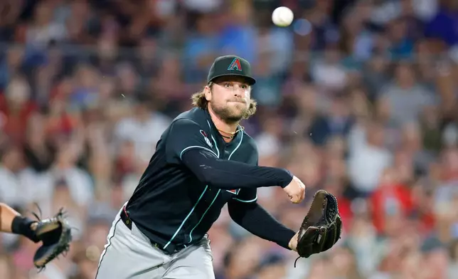 Arizona Diamondbacks pitcher Kevin Ginkel makes a throw to first base during the sixth inning of a baseball game against the Boston Red Sox Tuesday, Aug. 18, 2026, in Boston. (AP Photo/CJ Gunther)