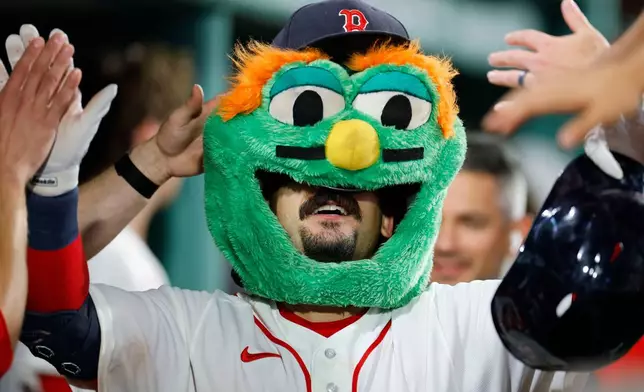 Boston Red Sox designated hitter Mickey Gasper celebrates in the dug out after hitting a solo home run during the sixth inning of a baseball game against the Arizona Diamondbacks Tuesday, Aug. 18, 2026, in Boston. (AP Photo/CJ Gunther)