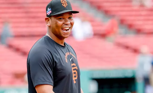 San Francisco Giants' Rafael Devers reacts to being back at Fenway Park before a baseball game against the Boston Red Sox, Friday, Aug. 21, 2026, in Boston. (AP Photo/Greg M. Cooper)