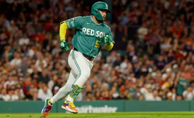Boston Red Sox's Wilyer Abreu heads toward first base after hitting an RBI triple during the sixth inning of a baseball game against the San Francisco Giants, Friday, Aug. 21, 2026, in Boston. (AP Photo/Greg M. Cooper)