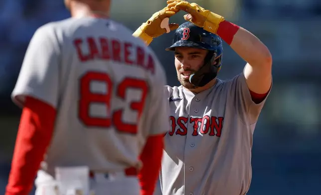 Boston Red Sox's Caleb Durbin, right, reacts after hitting an RBI single during the first inning of a baseball game against the Los Angeles Dodgers, Sunday, Aug. 2, 2026, in Los Angeles. (AP Photo/Caroline Brehman)