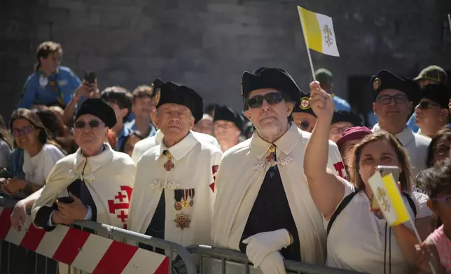 Faithful wait for Pope Leo XIV outside the Basilica during his visit to San Marino, Saturday, Aug. 22, 2026. (AP Photo/Andrew Medichini)