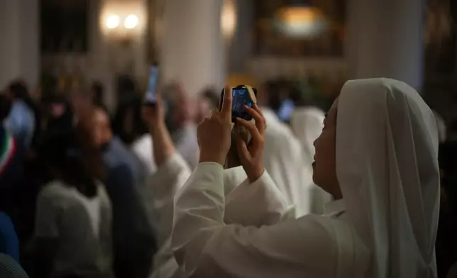 Faithful wait for Pope Leo XIV inside the Basilica during his visit to San Marino, Saturday, Aug. 22, 2026. (AP Photo/Andrew Medichini)