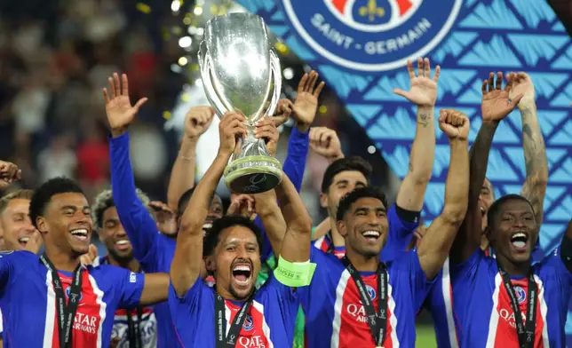 PSG's players lift the trophy during celebrations at the end of the UEFA Super Cup soccer match between Paris Saint-Germain and Aston Villa in Salzburg, Austria, Wednesday, Aug.12, 2026. (AP Photo/Heinz-Peter Bader)
