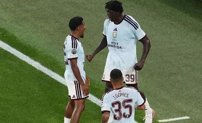 Aston Villa's Brian Madjo, right, celebrates after scoring his side's first goal during the UEFA Super Cup soccer match between Paris Saint-Germain and Aston Villa in Salzburg, Austria, Wednesday, Aug. 12, 2026. (AP Photo/Darko Vojinovic)