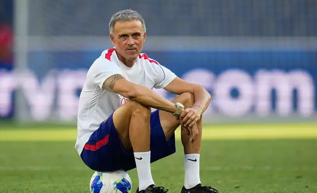 PSG's head coach Luis Enrique sits on a ball during a training session ahead of the UEFA Super Cup soccer match against Aston Villa in Salzburg, Austria, Tuesday, Aug. 11, 2026. (AP Photo/Darko Bandic)