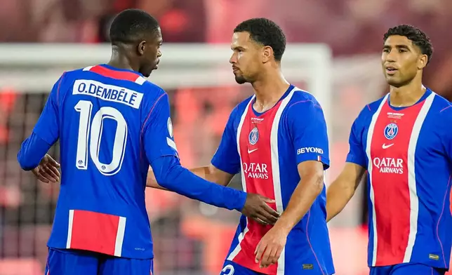 PSG's Ousmane Dembele, left, talks with PSG's Warren Zaire-Emery, center, as they celebrate PSG's Desire Doue scoring their side's second goal during the UEFA Super Cup soccer match between Paris Saint-Germain and Aston Villa in Salzburg, Austria, Wednesday, Aug.12, 2026. (AP Photo/Darko Bandic)
