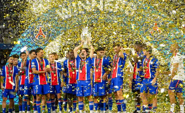PSG's Vitinha lifts the trophy during celebrations at the end of the UEFA Super Cup soccer match between Paris Saint-Germain and Aston Villa in Salzburg, Austria, Wednesday, Aug.12, 2026. (AP Photo/Darko Bandic)