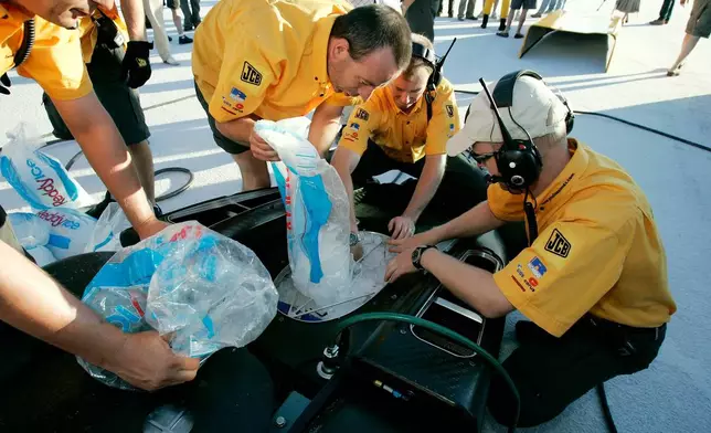 FILE - Bags of ice are loaded into the vehicle by crew members to act as a radiator before British driver Andy Green set a new unofficial world diesel powered land speed record of over 328 mph over two runs Tuesday, Aug. 22, 2006, on the Bonneville Salt Flats of Utah. (AP Photo/Douglas C. Pizac,File)