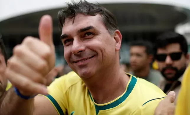 Opposition presidential candidate Flavio Bolsonaro gives a thumbs-up to supporters as he arrives at a hotel before his campaign rally in Rio de Janeiro, Brazil, Sunday, Aug. 16, 2026. (AP Photo/Bruna Prado)