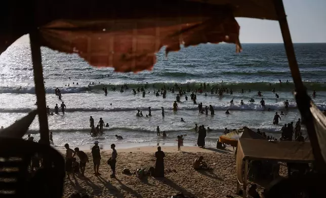 Palestinians cool off in the Mediterranean Sea during a heat wave in Nuseirat, central Gaza Strip, Thursday, July 30, 2026. (AP Photo/Abdel Kareem Hana)