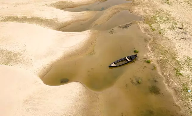 Usually submerged areas of the Danube River are exposed amid exceptionally low water levels, in Rasova, Romania, Monday, Aug. 3 2026. (AP Photo/ Vadim Ghirda)